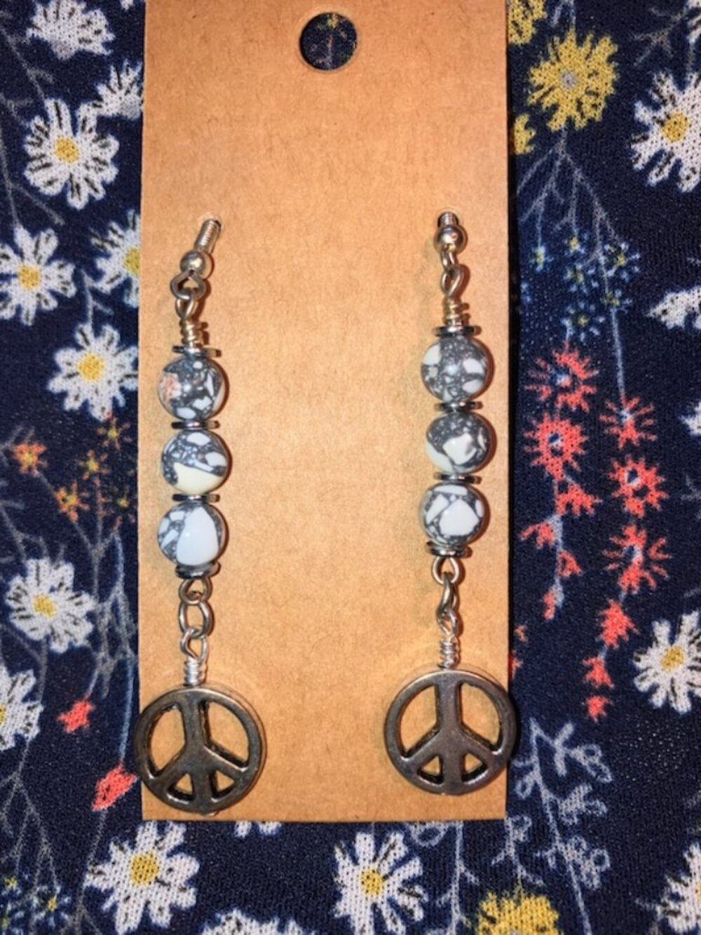 Handmade drop earrings with peace sign and white and gray beads